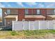 Townhome's backyard features a well maintained privacy fence with a grassy and gravel area at 915 Tj Dr, Monroe, NC 28112