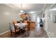 Bright dining area with a round table, elegant chairs, and stylish lighting fixture at 915 Tj Dr, Monroe, NC 28112