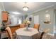 Cozy dining area with views into the kitchen, featuring a round table and four chairs at 915 Tj Dr, Monroe, NC 28112