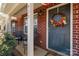 Inviting front entrance with brick facade, decorative wreath, and covered porch with seating at 915 Tj Dr, Monroe, NC 28112