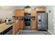 Well-lit kitchen featuring stainless steel appliances, wooden cabinetry, and granite countertops at 915 Tj Dr, Monroe, NC 28112
