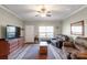 Cozy living room featuring hardwood floors, a ceiling fan, and ample natural light at 915 Tj Dr, Monroe, NC 28112