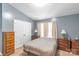 Well-lit main bedroom with two side tables and a view of an expansive closet at 915 Tj Dr, Monroe, NC 28112