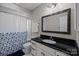 Cozy bathroom with a shower/tub combination and a dark vanity at 9334 Hunting Ct, Matthews, NC 28105