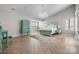 Serene bedroom with a unique aqua colored furniture set, a chandelier, and herringbone wood floors at 9334 Hunting Ct, Matthews, NC 28105