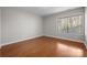 Bedroom featuring wood floors, neutral paint, and window with blinds at 9334 Hunting Ct, Matthews, NC 28105