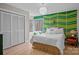 Stylish bedroom with a king bed, a funky green accent wall, and an abundance of natural light at 9334 Hunting Ct, Matthews, NC 28105