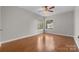 Sun-filled bedroom with hardwood floors and windows overlooking mature trees at 9334 Hunting Ct, Matthews, NC 28105
