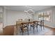 Elegant dining room with hardwood floors, statement lighting fixture, and a large window at 9334 Hunting Ct, Matthews, NC 28105