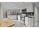 Bright kitchen with white cabinets, stainless steel appliances, granite countertops, and a window with natural light at 9334 Hunting Ct, Matthews, NC 28105