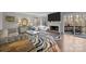 Well-lit living room boasts a fireplace, large windows, and a zebra-print rug, blending comfort and style at 9334 Hunting Ct, Matthews, NC 28105