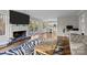 Spacious living area featuring a fireplace, hardwood floors, and a zebra-print rug, leading to a modern dining area at 9334 Hunting Ct, Matthews, NC 28105