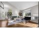 Spacious living room with hardwood floors, large window, a piano, and bright, natural light at 9334 Hunting Ct, Matthews, NC 28105