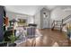 Bright living room with hardwood floors, a vaulted ceiling, piano, and large window with natural light at 9334 Hunting Ct, Matthews, NC 28105