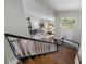 View from stairs of the open floor plan with grand chandelier and vaulted ceilings at 9334 Hunting Ct, Matthews, NC 28105