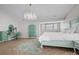 Tranquil bedroom with a unique chandelier, aqua-colored furniture, and herringbone wood floors at 9334 Hunting Ct, Matthews, NC 28105