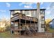 Multi-level home with large wood decks and a brick chimney, offering great outdoor living spaces at 9334 Hunting Ct, Matthews, NC 28105