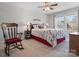 Bedroom featuring a ceiling fan, a window and a wooden rocking chair at 9611 Rayneridge Dr, Huntersville, NC 28078