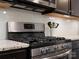 Stainless steel gas range with microwave and grey backsplash offers a modern cooking space at 9611 Rayneridge Dr, Huntersville, NC 28078