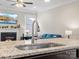Open concept kitchen with granite counters, stainless faucet, and views of the living room fireplace at 9611 Rayneridge Dr, Huntersville, NC 28078