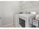 Laundry room with white appliances, tile floors and overhead shelving at 9611 Rayneridge Dr, Huntersville, NC 28078