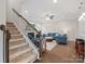 Bright and airy living room with a staircase, plush furniture, and a cozy fireplace at 9611 Rayneridge Dr, Huntersville, NC 28078