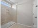 Tiled walk-in shower with glass door, niche, and decorative tile accent strip at 9611 Rayneridge Dr, Huntersville, NC 28078
