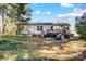 The backyard has a wooden deck and some yard furniture in the grass at 1001 E 8Th Ave, Gastonia, NC 28054