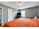 Bedroom features a dark dresser, plush bedding, and windows for natural light at 1001 E 8Th Ave, Gastonia, NC 28054