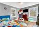 Vibrant bedroom featuring a blue racecar bed, natural light, and hardwood floors at 1001 E 8Th Ave, Gastonia, NC 28054