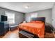 Cozy bedroom with hardwood floors, two windows for natural light, and a sleek black headboard at 1001 E 8Th Ave, Gastonia, NC 28054