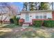 Inviting front entrance with brick accents, stone steps, and a well-maintained lawn with trimmed bushes at 1001 E 8Th Ave, Gastonia, NC 28054