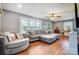 Bright living room with large windows, hardwood floors, and comfortable seating, perfect for relaxation at 1001 E 8Th Ave, Gastonia, NC 28054