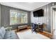 Bright home office with a large window, desk, and gray paneled walls at 1001 E 8Th Ave, Gastonia, NC 28054