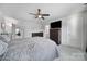 A bright primary bedroom showcasing plush carpets, a ceiling fan, and a flat screen television at 109 Watrous Way, Mooresville, NC 28115