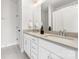 Modern bathroom featuring double vanity with quartz countertop and framed mirror and tiled glass enclosed shower at 110 Wesser St, Davidson, NC 28036