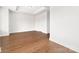 Empty, spacious bedroom featuring warm wood floors, tray ceiling, and neutral decor at 110 Wesser St, Davidson, NC 28036
