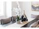 Inviting dining area showcasing neutral decor with a decorative table runner, floral arrangement, and decorative vases at 110 Wesser St, Davidson, NC 28036