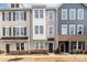 View of townhomes with neutral siding, black door awnings, and manicured front lawns at 110 Wesser St, Davidson, NC 28036