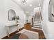 Foyer showcasing hardwood floors, white walls, a staircase and an area for a bench at 110 Wesser St, Davidson, NC 28036