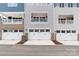 Attached garages on a multi-Gathering building are spacious and secured with white doors and black hardware at 110 Wesser St, Davidson, NC 28036