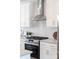Bright kitchen featuring stainless steel appliances, white cabinetry, and modern tile backsplash at 110 Wesser St, Davidson, NC 28036