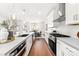 This modern kitchen boasts stainless steel appliances, granite countertops, and an island with a sink at 110 Wesser St, Davidson, NC 28036