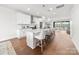 Bright kitchen showcasing a large island with bar seating, stainless steel appliances, and hardwood floors at 110 Wesser St, Davidson, NC 28036
