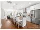 This kitchen has a large island, stainless steel appliances, and hardwood floors. The kitchen is open to the dining area at 110 Wesser St, Davidson, NC 28036