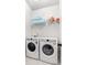 Convenient laundry room features a full-size washer and dryer with storage shelf above at 110 Wesser St, Davidson, NC 28036