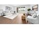 Spacious living room featuring hardwood floors, access to a balcony, and neutral furniture at 110 Wesser St, Davidson, NC 28036