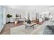 Open-concept living room with hardwood floors, white walls, and an eat-in kitchen at 110 Wesser St, Davidson, NC 28036