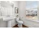This stylish half-bath features modern fixtures and a large window for plenty of natural light at 110 Wesser St, Davidson, NC 28036