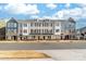 A row of new townhomes showcases modern architecture and inviting exteriors at 110 Wesser St, Davidson, NC 28036